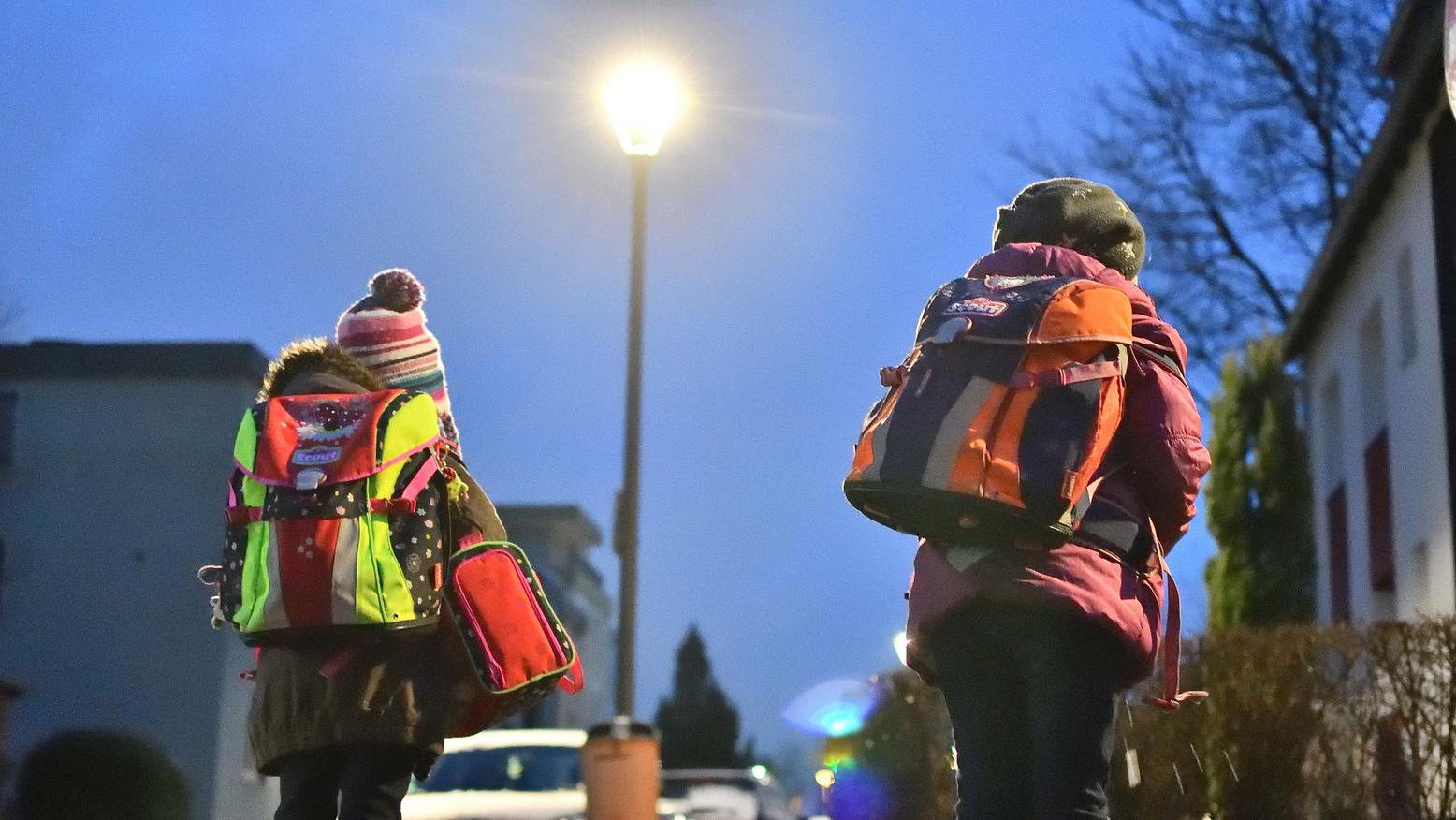 Zwei Kinder auf dem beleuchteten Schulweg