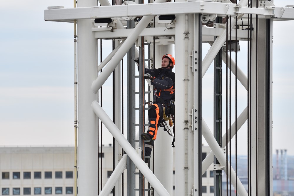 Ein Höhenretter klettert in einem Gerüstturm 