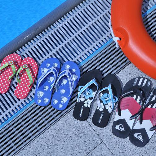 Flip-Flops stehen am Beckenrand aufgereiht im Ostbad in Bochum.