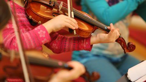 Kinder spielen Geige