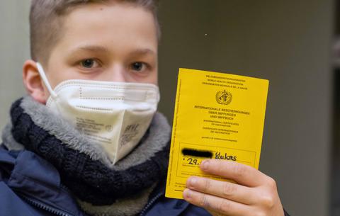 Ein Junge mit seinem Impfpass