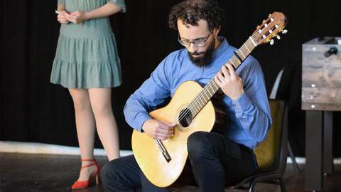 Ein Mann mit einer Gitarre und eine Frau machen Musik
