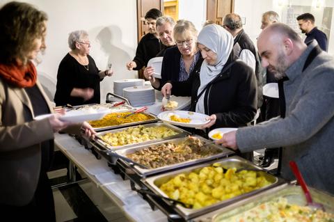 Teilnehmende bedienen sich am Buffet